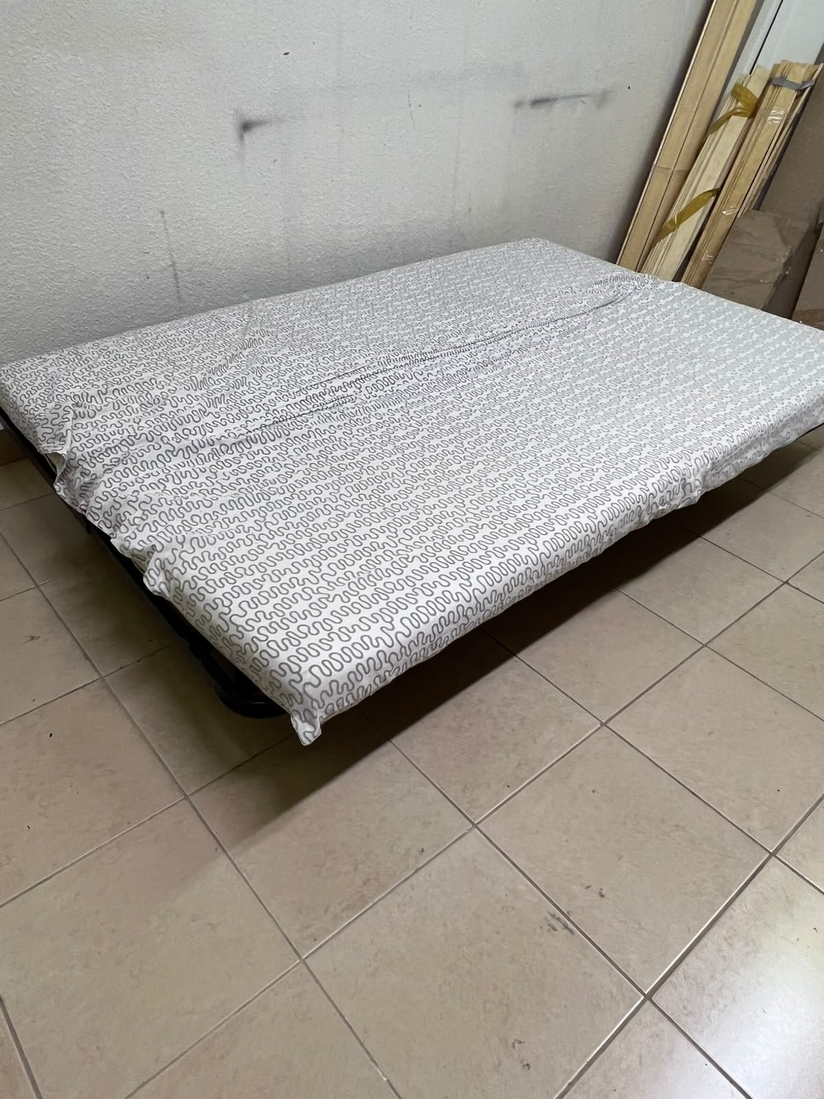 A foldable metal sofa bed (converting into a bed)—the famous IKEA NYHAMN model—featuring a grey-and-white patterned fabric cover and a black frame. - Image 6