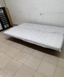A foldable metal sofa bed (converting into a bed)—the famous IKEA NYHAMN model—featuring a grey-and-white patterned fabric cover and a black frame. - Image 7