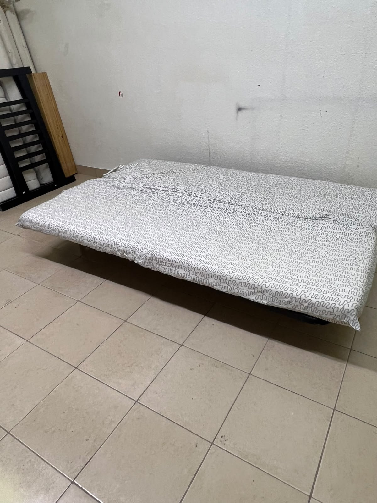 A foldable metal sofa bed (converting into a bed)—the famous IKEA NYHAMN model—featuring a grey-and-white patterned fabric cover and a black frame. - Image 7