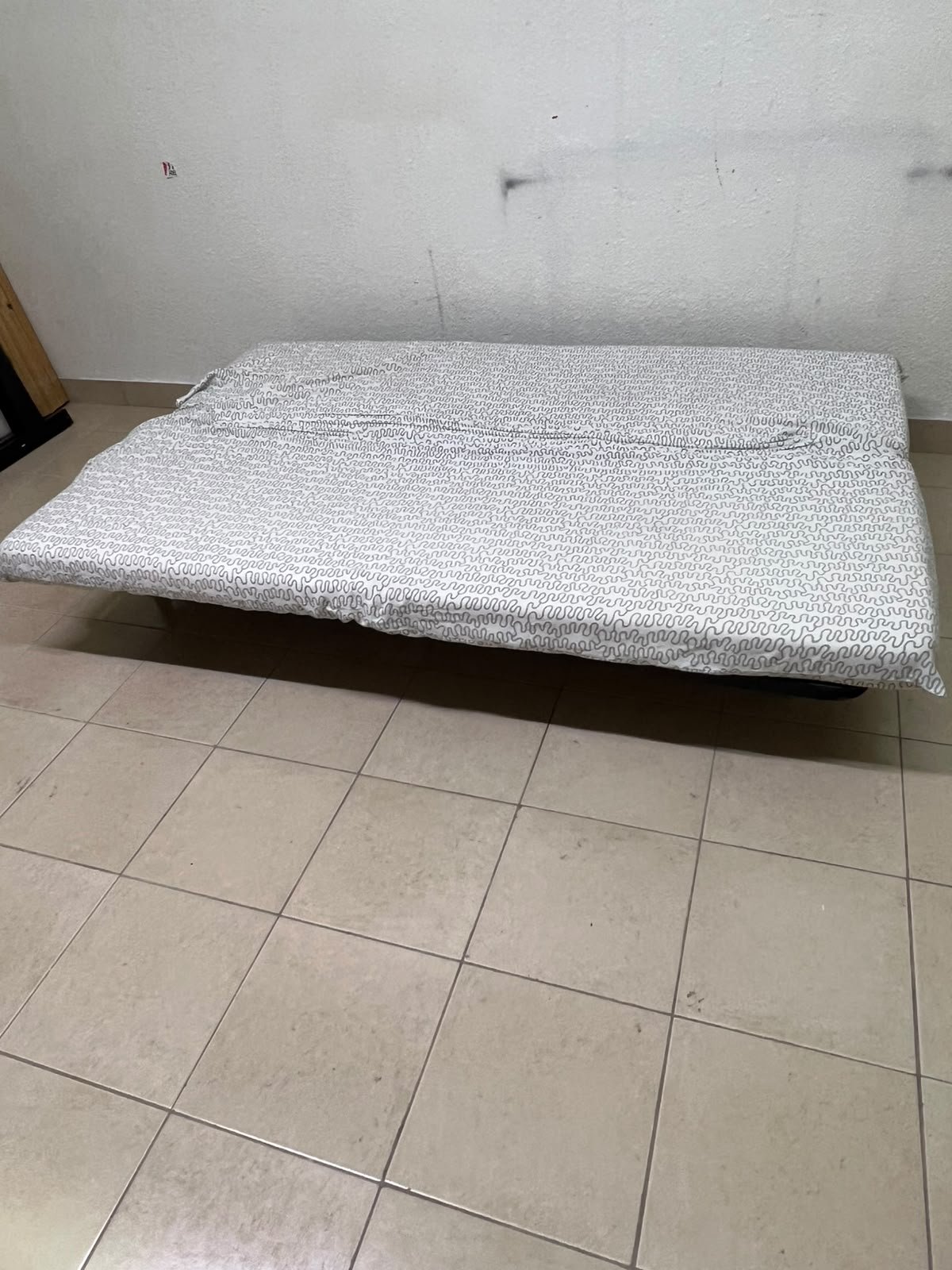 A foldable metal sofa bed (converting into a bed)—the famous IKEA NYHAMN model—featuring a grey-and-white patterned fabric cover and a black frame. - Image 8