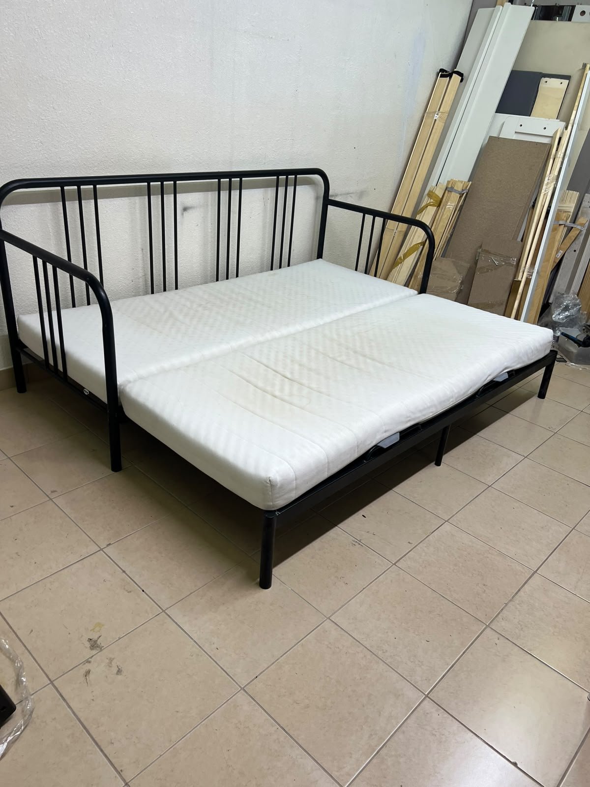 This is a black metal daybed that extends to convert into a double bed or a sofa; it closely resembles the IKEA FYRESDAL daybed frame (80x200 cm).