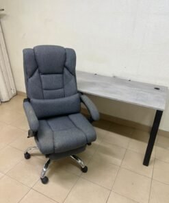 A modern office desk featuring a wooden top with a grey cement-effect finish and black metal legs, accompanied by a suspended side drawer unit in black and white, and a high-back swivel office chair upholstered in grey fabric. - Image 8