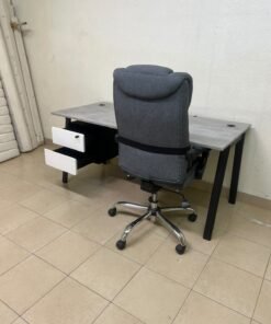A modern office desk featuring a wooden top with a grey cement-effect finish and black metal legs, accompanied by a suspended side drawer unit in black and white, and a high-back swivel office chair upholstered in grey fabric. - Image 5
