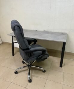 A modern office desk featuring a wooden top with a grey cement-effect finish and black metal legs, accompanied by a suspended side drawer unit in black and white, and a high-back swivel office chair upholstered in grey fabric. - Image 11