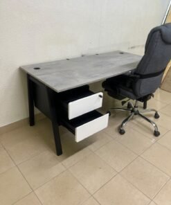 A modern office desk featuring a wooden top with a grey cement-effect finish and black metal legs, accompanied by a suspended side drawer unit in black and white, and a high-back swivel office chair upholstered in grey fabric. - Image 12