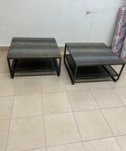 A set of two coffee tables featuring a modern industrial design; each boasts a wooden tabletop with a rustic or distressed look, a sturdy black metal frame and base, and a practical bottom shelf. - Image 7