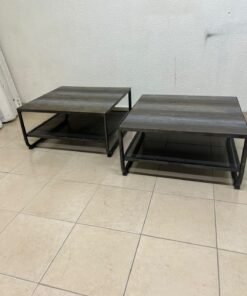 A set of two coffee tables featuring a modern industrial design; each boasts a wooden tabletop with a rustic or distressed look, a sturdy black metal frame and base, and a practical bottom shelf. - Image 2