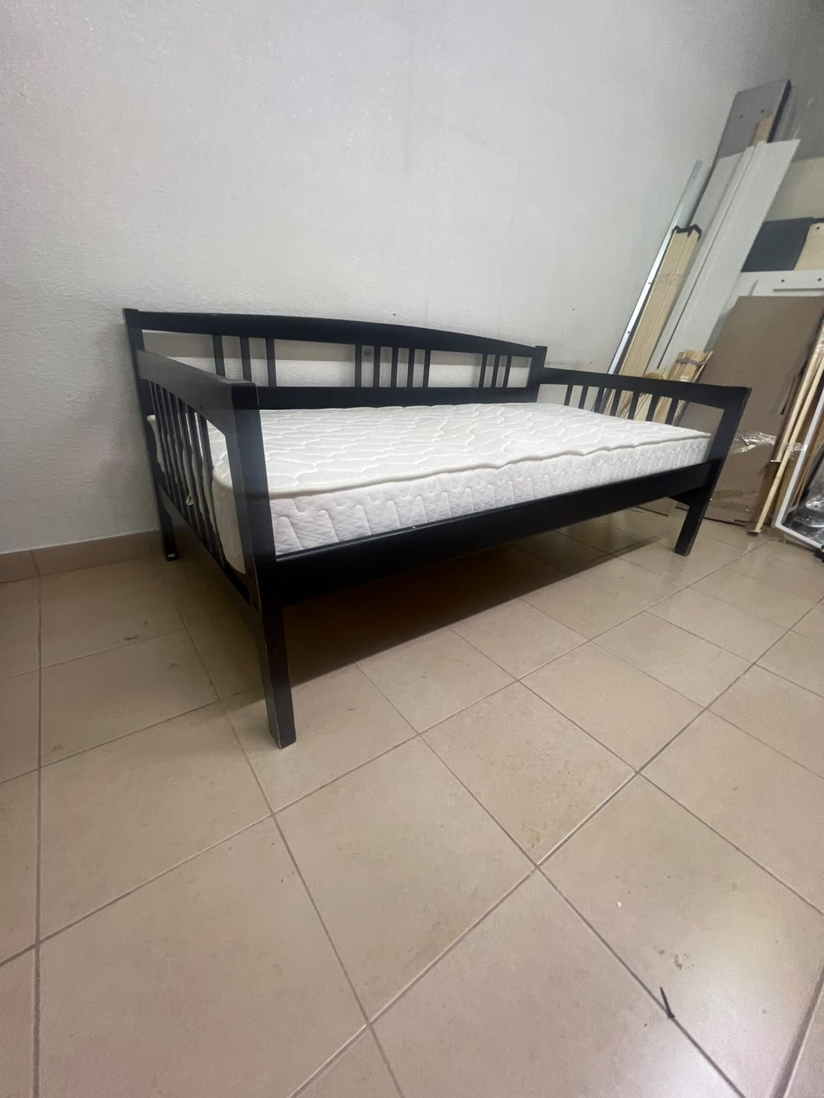The image appears to show a dark black wooden daybed, featuring rails on three sides and a standard double size with a white mattress. - Image 2