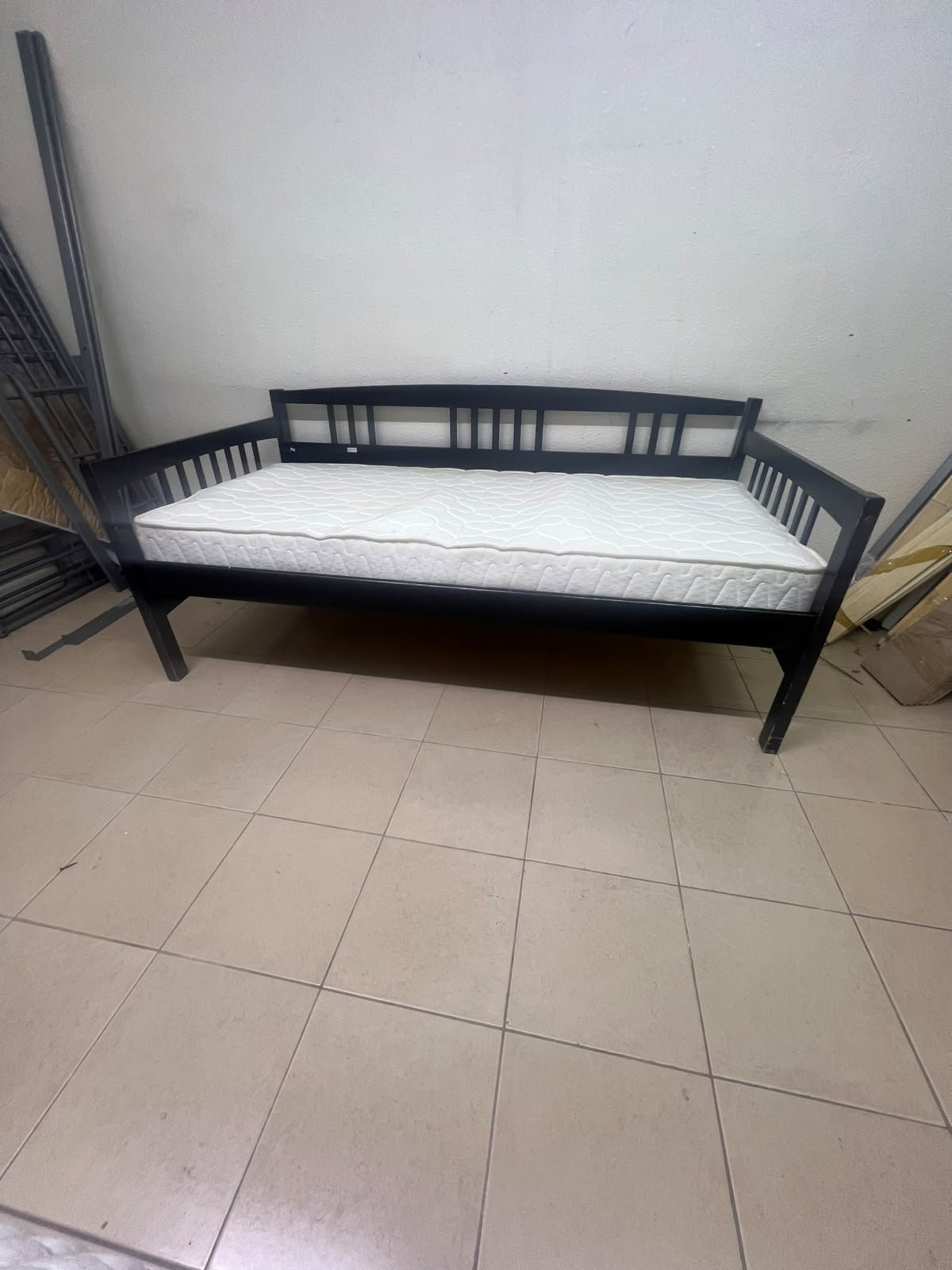 The image appears to show a dark black wooden daybed, featuring rails on three sides and a standard double size with a white mattress. - Image 4
