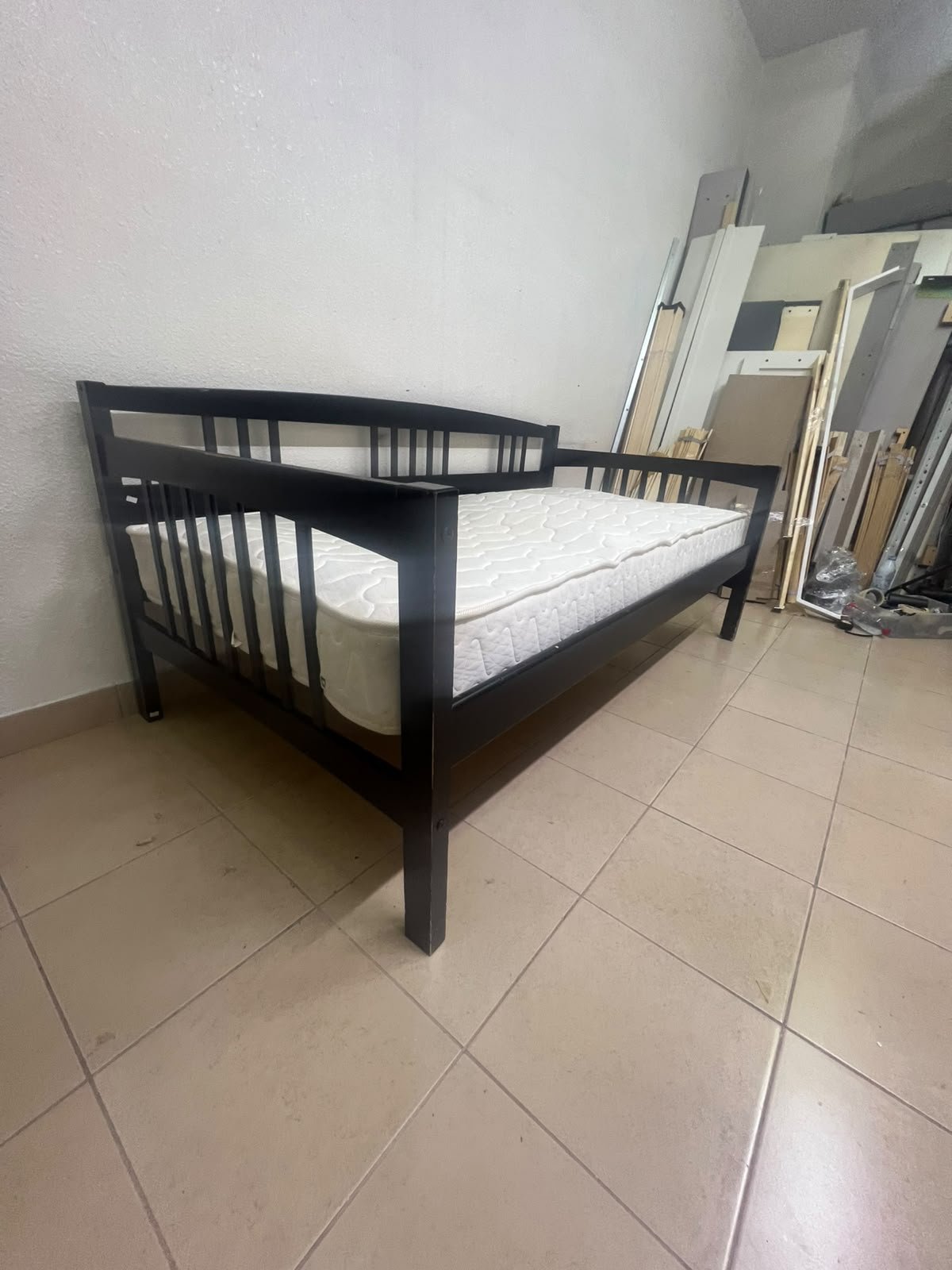 The image appears to show a dark black wooden daybed, featuring rails on three sides and a standard double size with a white mattress. - Image 12