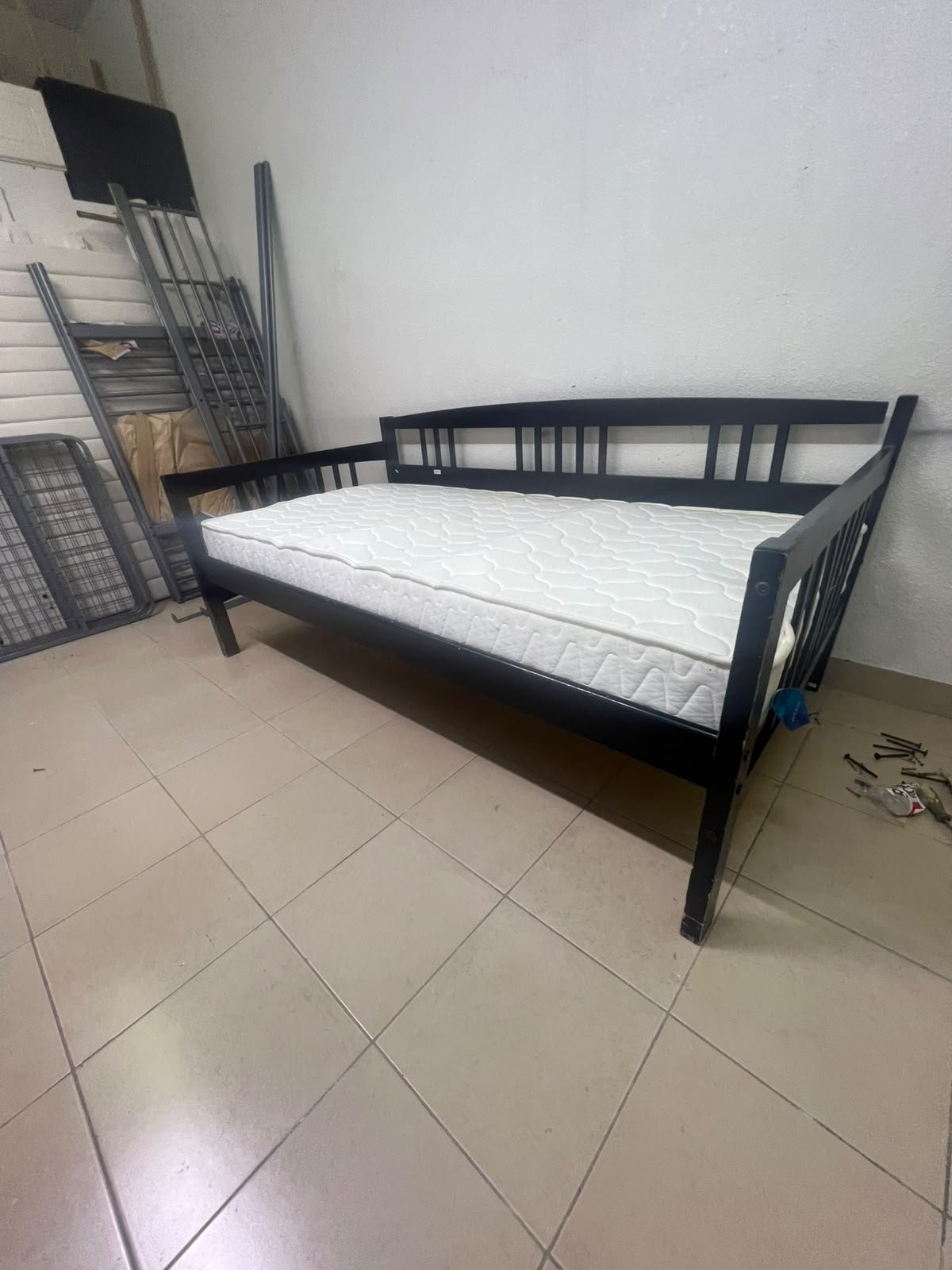 The image appears to show a dark black wooden daybed, featuring rails on three sides and a standard double size with a white mattress. - Image 11