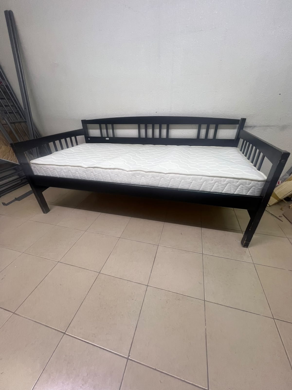 The image appears to show a dark black wooden daybed, featuring rails on three sides and a standard double size with a white mattress. - Image 10