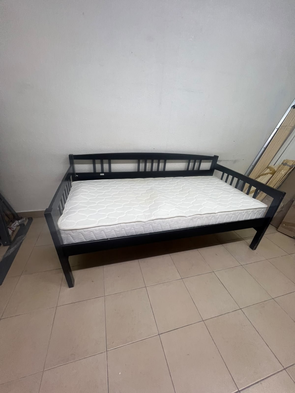 The image appears to show a dark black wooden daybed, featuring rails on three sides and a standard double size with a white mattress. - Image 9