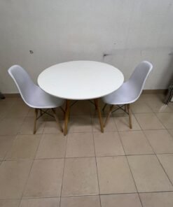 A modern Scandinavian-style round white dining table with wooden legs, accompanied by two matching white chairs. - Image 2