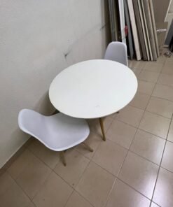 A modern Scandinavian-style round white dining table with wooden legs, accompanied by two matching white chairs. - Image 10