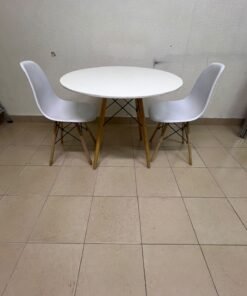 A modern Scandinavian-style round white dining table with wooden legs, accompanied by two matching white chairs. - Image 9