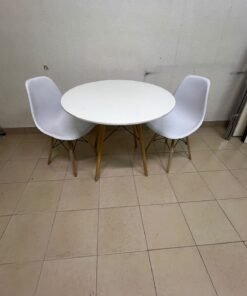 A modern Scandinavian-style round white dining table with wooden legs, accompanied by two matching white chairs. - Image 12