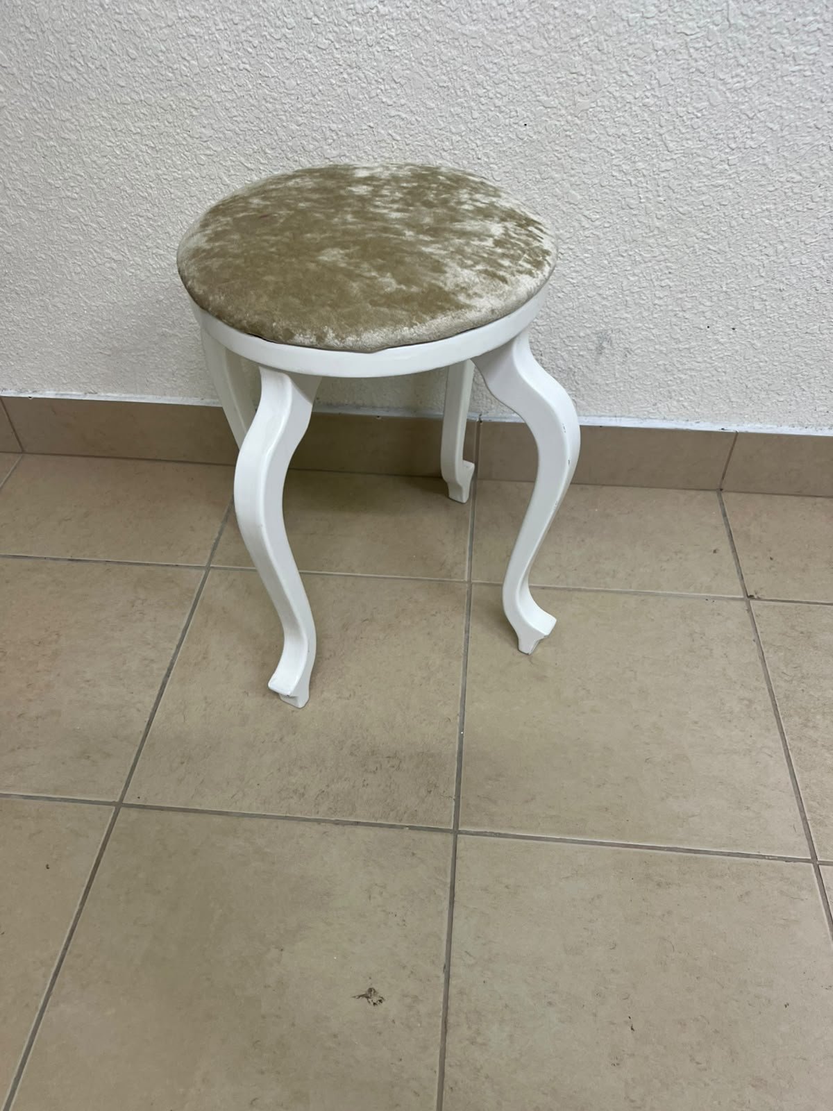 A vanity stool featuring a classic French or "Queen Anne" design, characterized by a white wooden frame with cabriole legs and a round seat upholstered in beige or light-gold velvet fabric. - Image 2