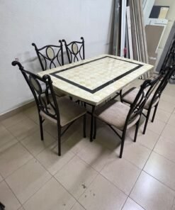 A dining table featuring a metal design with a decorative top and a set of matching upholstered chairs; it appears suitable for home use or a functional office setting. - Image 2