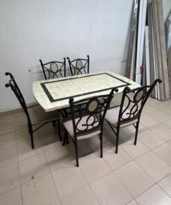 A dining table featuring a metal design with a decorative top and a set of matching upholstered chairs; it appears suitable for home use or a functional office setting. - Image 4