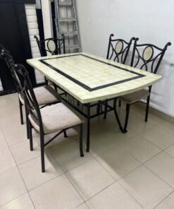 A dining table featuring a metal design with a decorative top and a set of matching upholstered chairs; it appears suitable for home use or a functional office setting. - Image 5