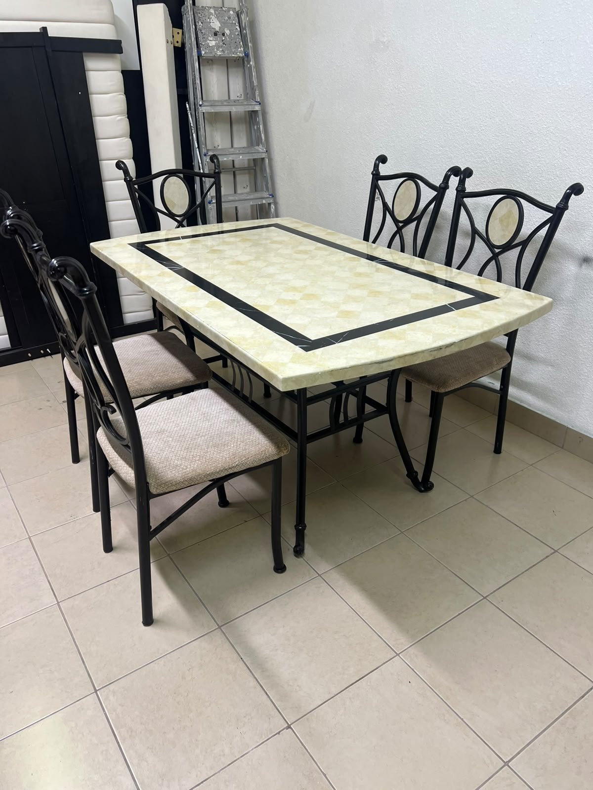 A dining table featuring a metal design with a decorative top and a set of matching upholstered chairs; it appears suitable for home use or a functional office setting. - Image 5