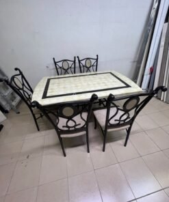 A dining table featuring a metal design with a decorative top and a set of matching upholstered chairs; it appears suitable for home use or a functional office setting. - Image 6