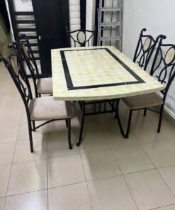 A dining table featuring a metal design with a decorative top and a set of matching upholstered chairs; it appears suitable for home use or a functional office setting. - Image 7