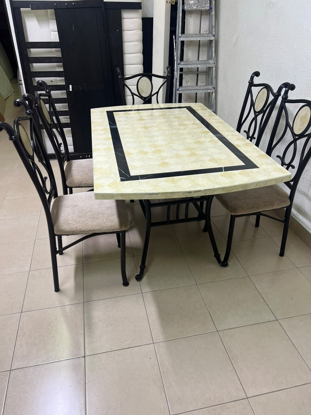 A dining table featuring a metal design with a decorative top and a set of matching upholstered chairs; it appears suitable for home use or a functional office setting. - Image 7