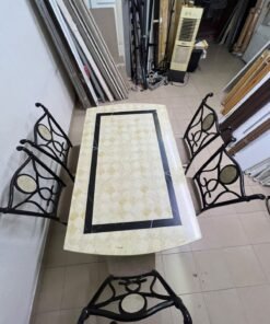 A dining table featuring a metal design with a decorative top and a set of matching upholstered chairs; it appears suitable for home use or a functional office setting. - Image 8
