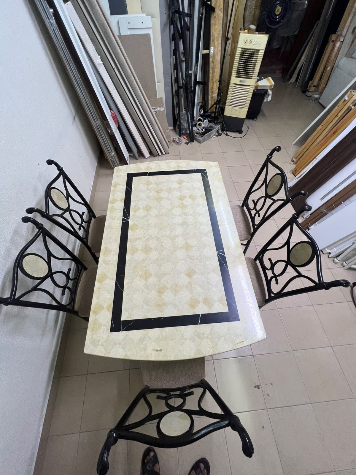 A dining table featuring a metal design with a decorative top and a set of matching upholstered chairs; it appears suitable for home use or a functional office setting. - Image 8