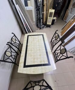 A dining table featuring a metal design with a decorative top and a set of matching upholstered chairs; it appears suitable for home use or a functional office setting. - Image 9