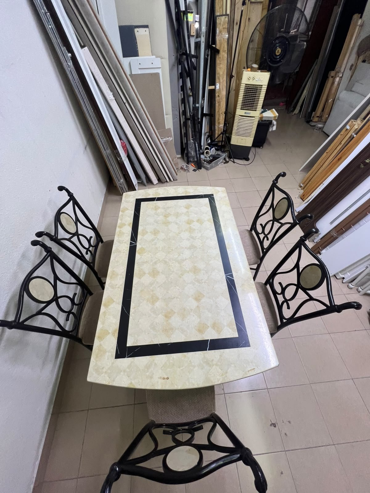 A dining table featuring a metal design with a decorative top and a set of matching upholstered chairs; it appears suitable for home use or a functional office setting. - Image 9