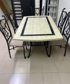 A dining table featuring a metal design with a decorative top and a set of matching upholstered chairs; it appears suitable for home use or a functional office setting. - Image 10