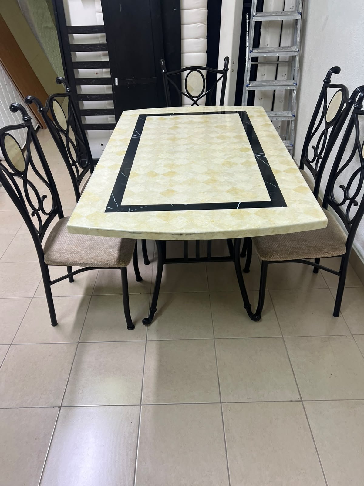 A dining table featuring a metal design with a decorative top and a set of matching upholstered chairs; it appears suitable for home use or a functional office setting. - Image 10