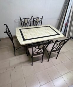A dining table featuring a metal design with a decorative top and a set of matching upholstered chairs; it appears suitable for home use or a functional office setting. - Image 11