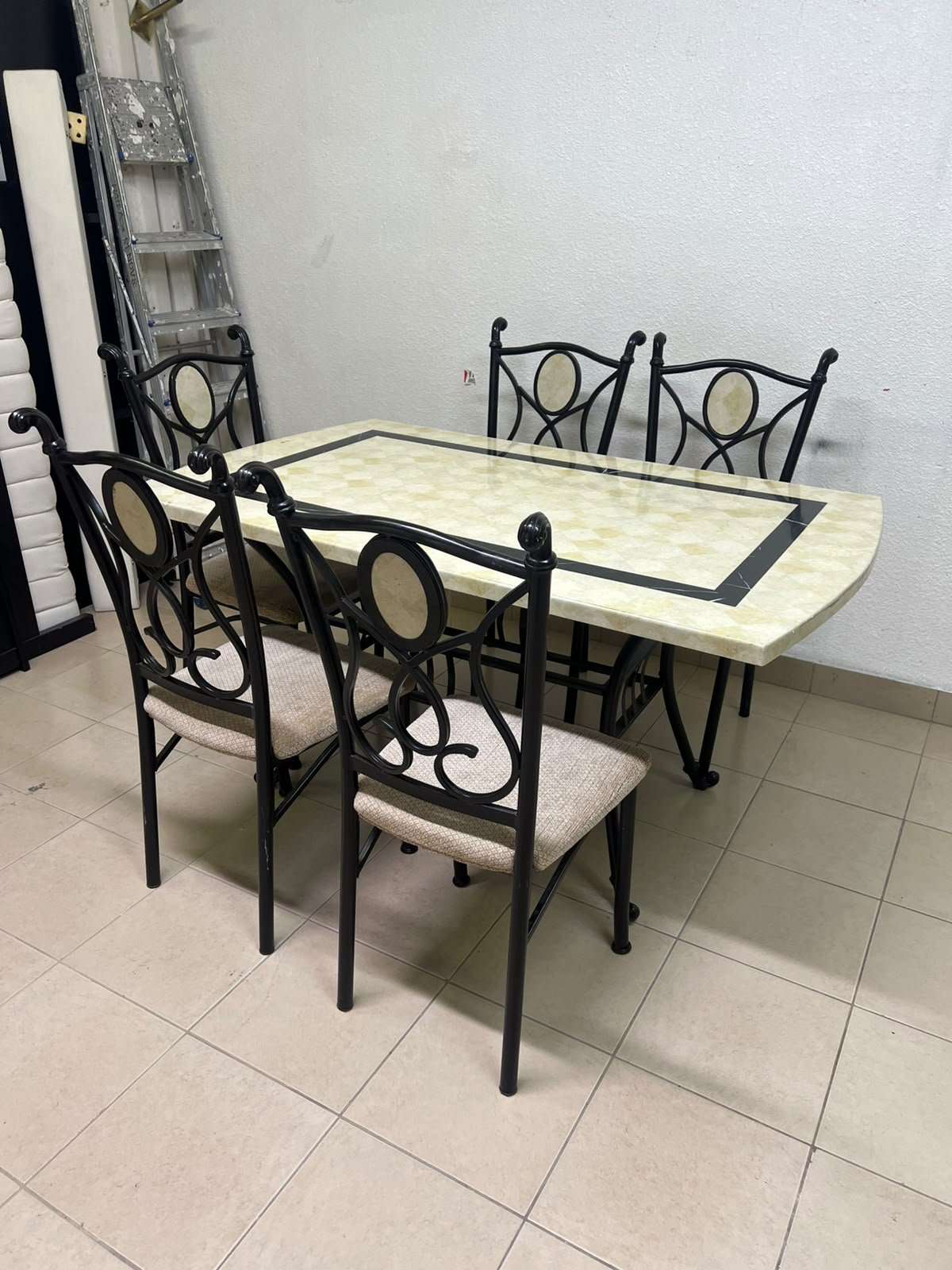 A dining table featuring a metal design with a decorative top and a set of matching upholstered chairs; it appears suitable for home use or a functional office setting. - Image 13