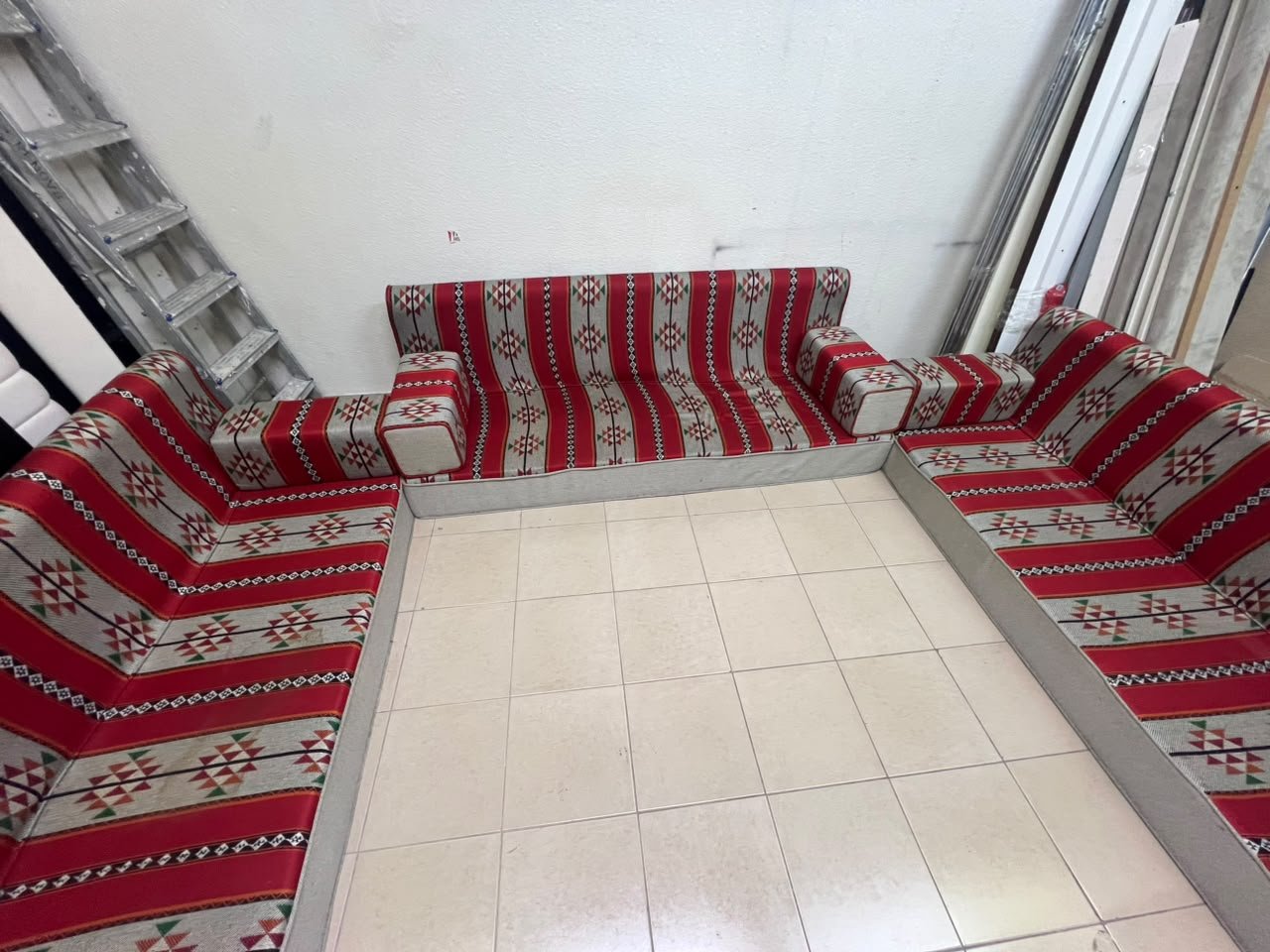 A traditional U-shaped floor seating set (Arabic *majlis*), upholstered in fabric featuring red, heritage-inspired Sadu patterns. - Image 7