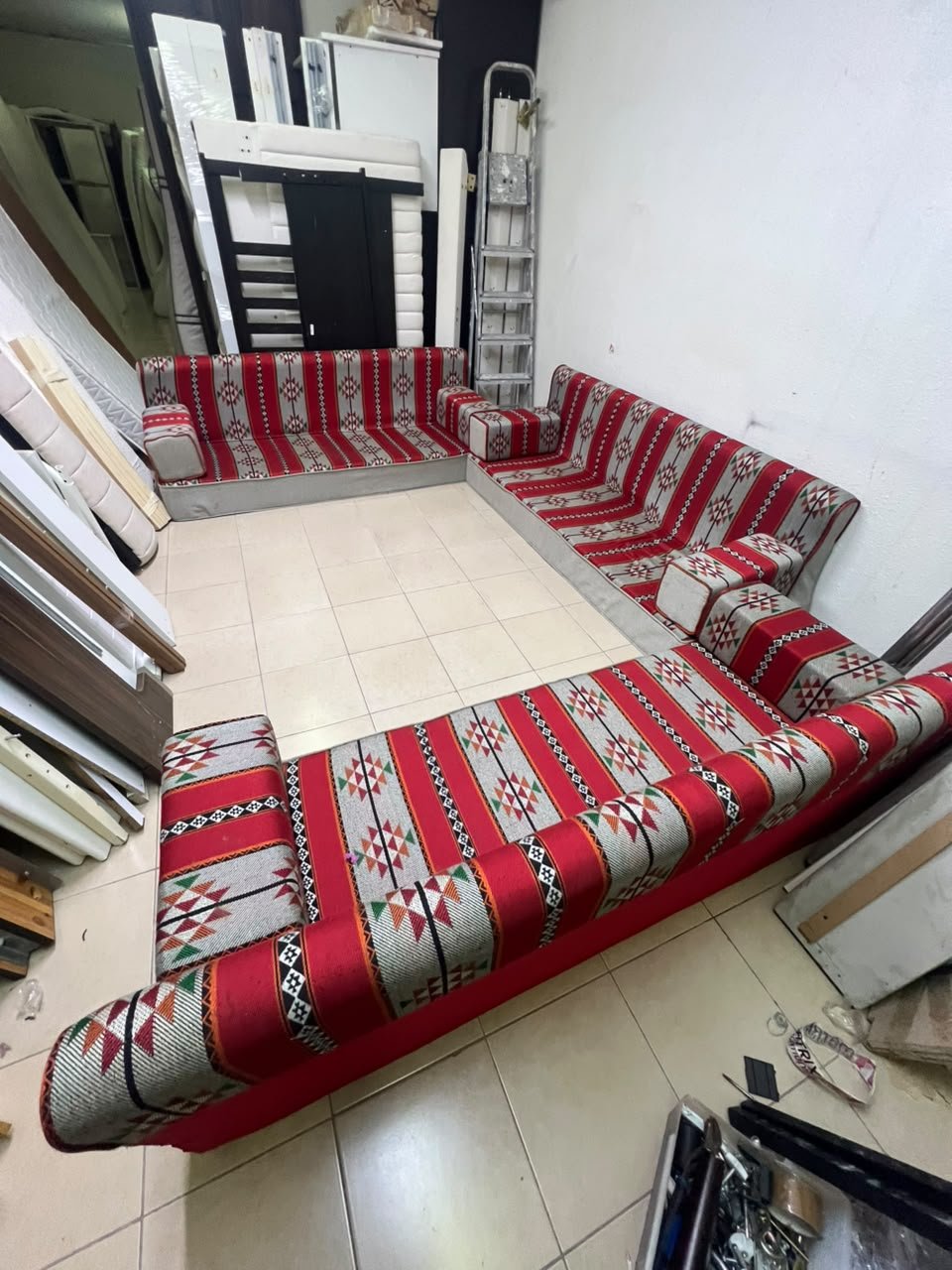 A traditional U-shaped floor seating set (Arabic *majlis*), upholstered in fabric featuring red, heritage-inspired Sadu patterns. - Image 8