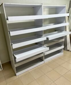 Commercial display shelving units—or slanted racks for organizing shoes or products—made of wood or white MDF. Each unit features several horizontal or slightly inclined shelves equipped with front edges to prevent products from falling. - Image 9