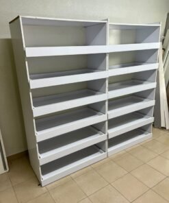 Commercial display shelving units—or slanted racks for organizing shoes or products—made of wood or white MDF. Each unit features several horizontal or slightly inclined shelves equipped with front edges to prevent products from falling. - Image 2