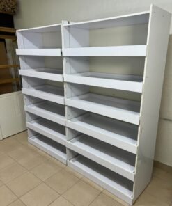 Commercial display shelving units—or slanted racks for organizing shoes or products—made of wood or white MDF. Each unit features several horizontal or slightly inclined shelves equipped with front edges to prevent products from falling. - Image 4