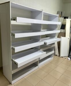 Commercial display shelving units—or slanted racks for organizing shoes or products—made of wood or white MDF. Each unit features several horizontal or slightly inclined shelves equipped with front edges to prevent products from falling. - Image 6