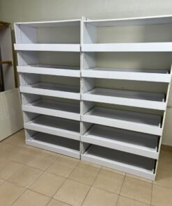 Commercial display shelving units—or slanted racks for organizing shoes or products—made of wood or white MDF. Each unit features several horizontal or slightly inclined shelves equipped with front edges to prevent products from falling. - Image 7