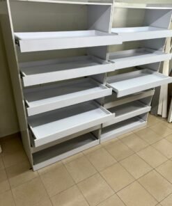 Commercial display shelving units—or slanted racks for organizing shoes or products—made of wood or white MDF. Each unit features several horizontal or slightly inclined shelves equipped with front edges to prevent products from falling. - Image 8