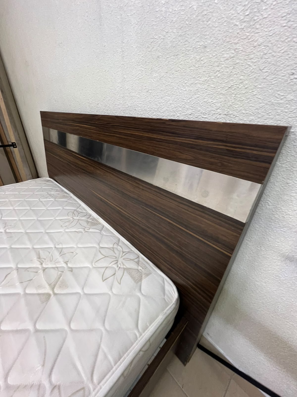 A dark brown wooden double bed featuring a headboard accented with a silver metal strip, and equipped with a white padded mattress. - Image 3