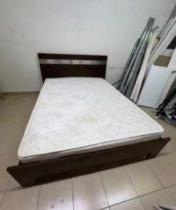 A dark brown wooden double bed featuring a headboard accented with a silver metal strip, and equipped with a white padded mattress. - Image 5