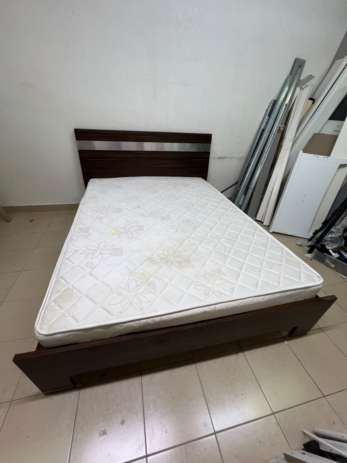 A dark brown wooden double bed featuring a headboard accented with a silver metal strip, and equipped with a white padded mattress. - Image 5