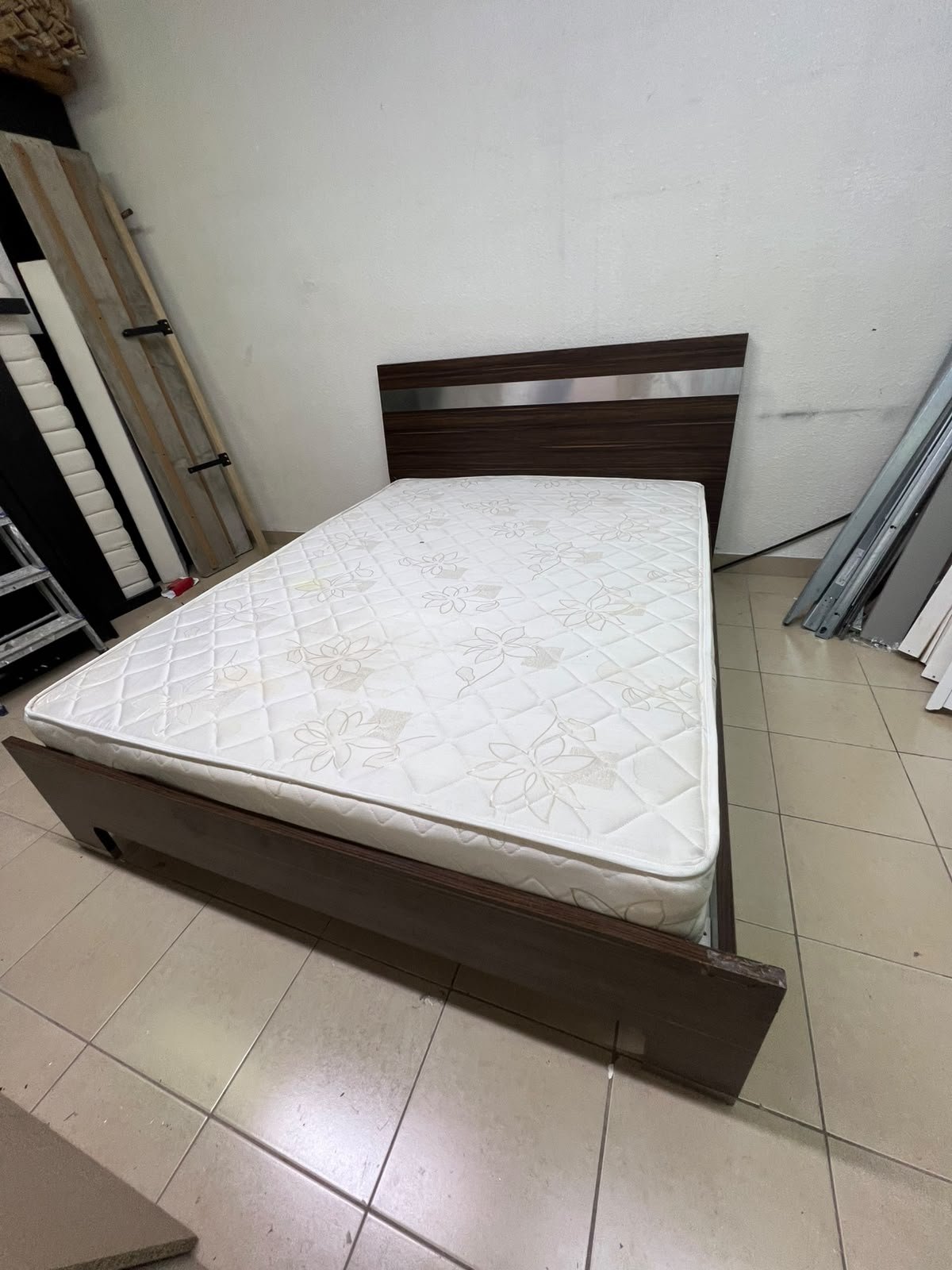 A dark brown wooden double bed featuring a headboard accented with a silver metal strip, and equipped with a white padded mattress. - Image 6