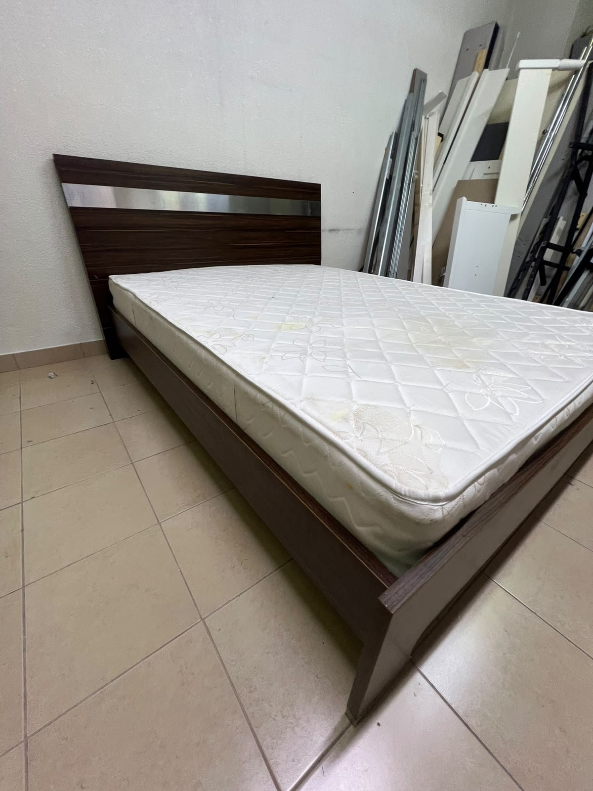 A dark brown wooden double bed featuring a headboard accented with a silver metal strip, and equipped with a white padded mattress. - Image 7
